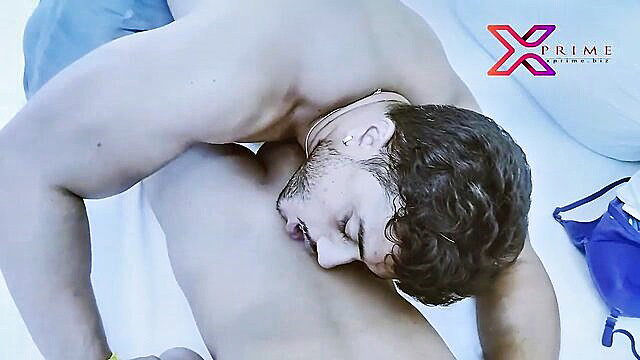 Muscular Desi guy in intense gay sex pose on bed