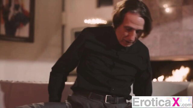 Man in black shirt gazes intently in EroticaX scene with Nella Jones