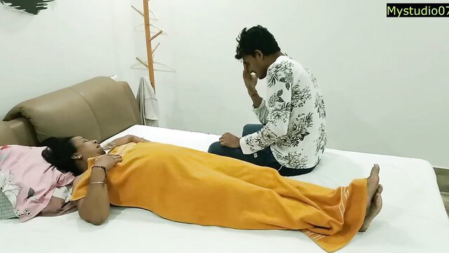 Hot Indian MILF aunty lies naked on bed with inexperienced boy kneeling nearby