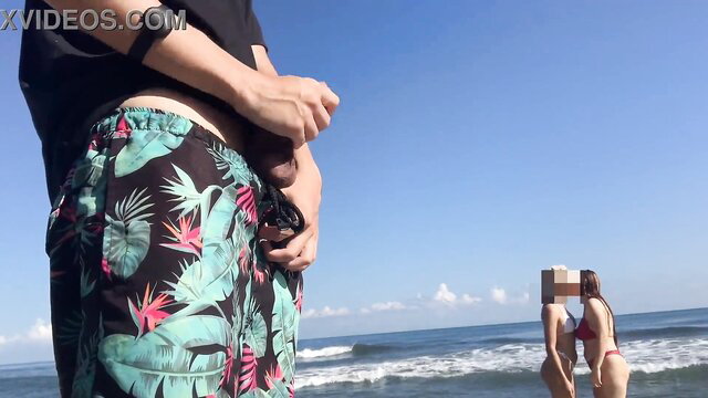 Megan Cockteaser grabs bulge in floral shorts at beach with bikini babe