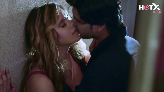 Curvy Hindi babe in red top passionately kisses stud against wall