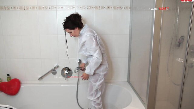 DeutscheHausfrau German MILF in tight white PVC Anzug bends over bathtub
