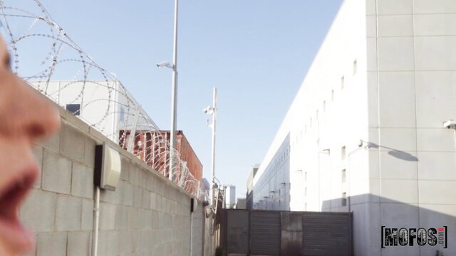 Arian Joy closeup face at prison fence, public spanking tease