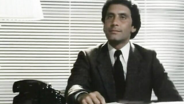 Hot retro 70s businessman in suit at desk, seductive Metro HD classic