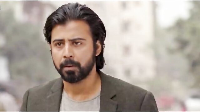 Handsome bearded Indian man in suit gazes pensively, amateur vibe