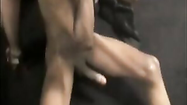 Black guy arms gripping muscular legs in intense gay anal scene