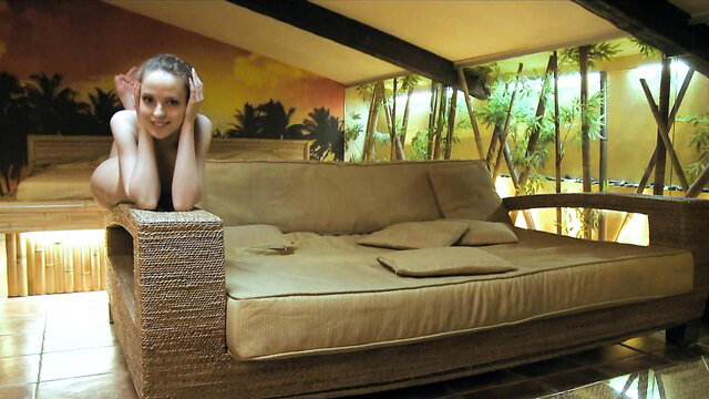 Nude brunette babe lounging seductively on couch in wild sex scene