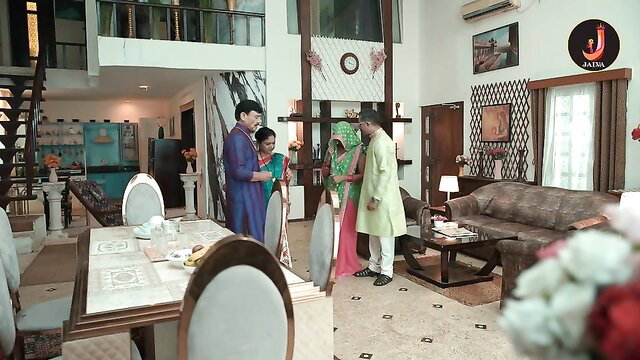 Indian couple in sarees and kurtas in luxurious home