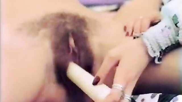 Hairy pussy closeup with dildo insertion by woman's hand