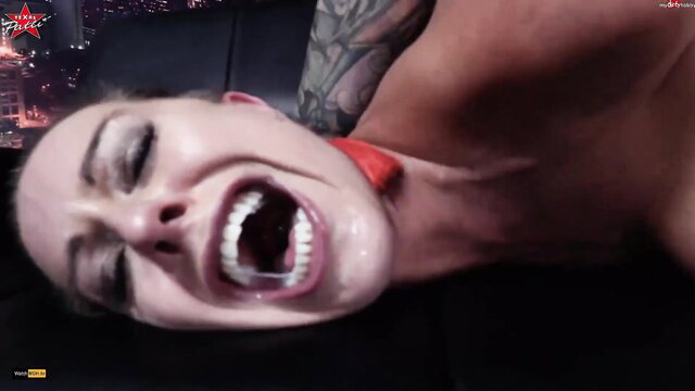 Texas Patti gagging in ecstasy, red collar, tattooed guy, city lights