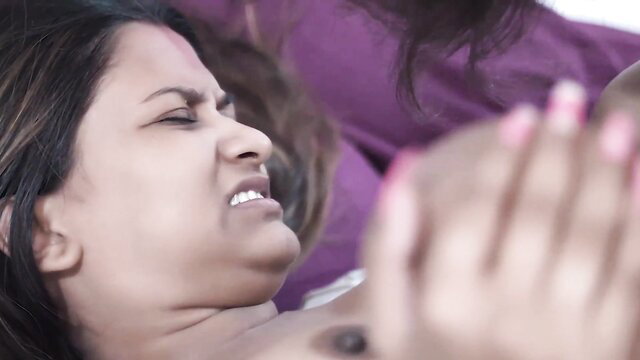 Young Indian wife grimacing in ecstasy as man grips her neck in intense action