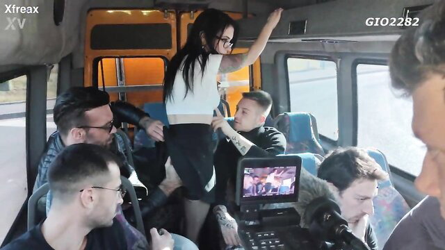 Dalila Dark stands in miniskirt on Xfreax bus BTS with Anna de Ville, Aubrey Black