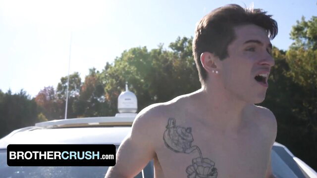 Hot tattooed white guy shirtless outdoors by police van