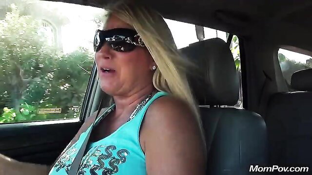 Busty blonde MILF Taelor in car POV, wearing tank top sunglasses