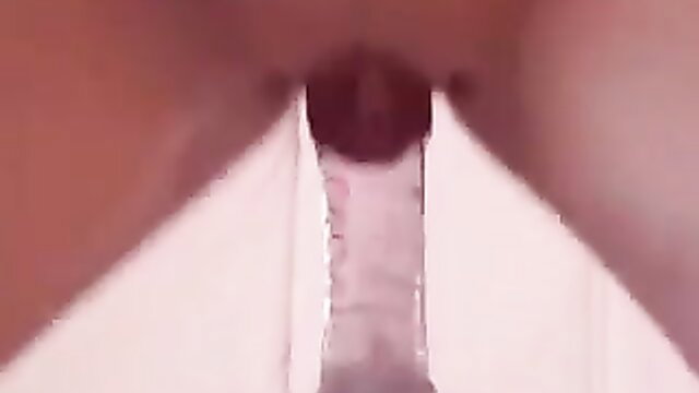 Busty babe's wet pussy penetrated by thick glass dildo in solo masturbation