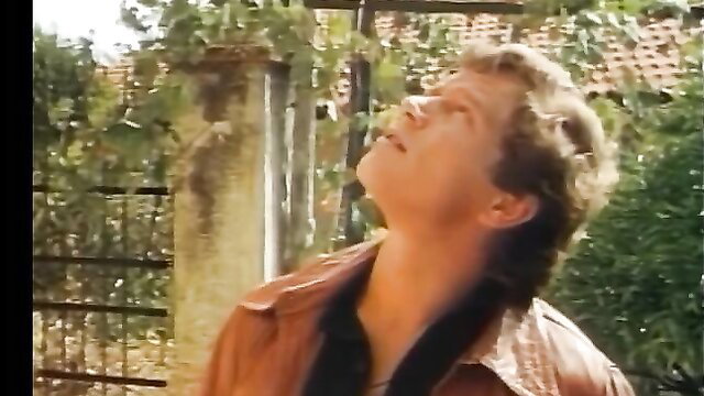 Hot 80s German guy in leather jacket looks up passionately, retro gay tease