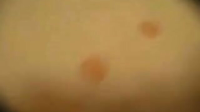 Blurry closeup of two tan nympho babes' faces with ecstatic expressions