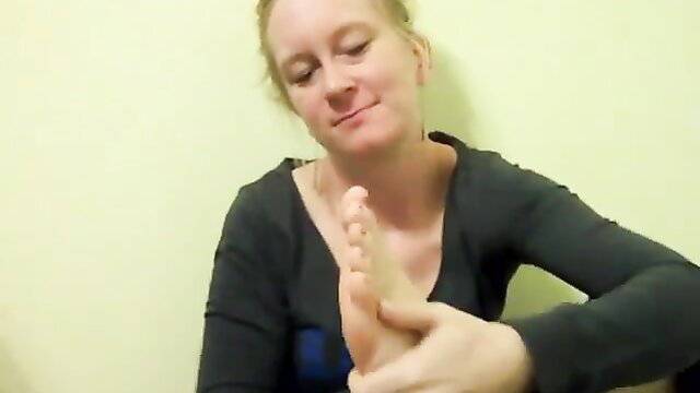 Redhead amateur girl massages her bare foot in steamy fetish video