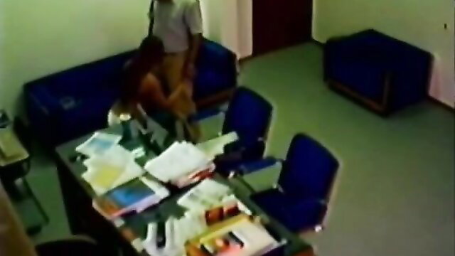 Woman giving handjob to a man in an office