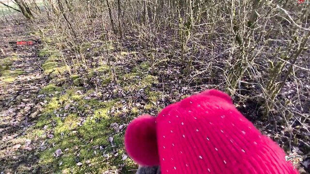 Jenny Stella in red pom-pom beanie in sunny forest POV tease