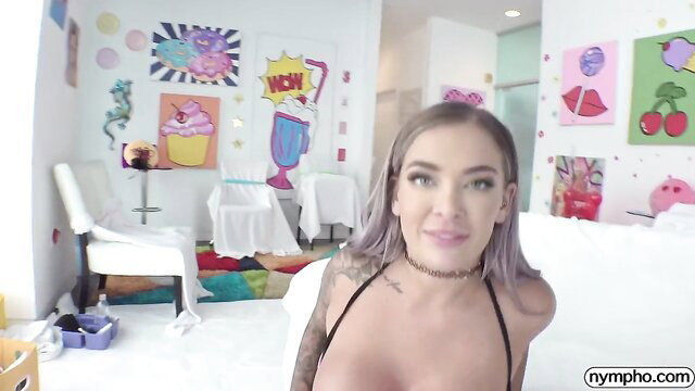 Blonde bombshell with massive tits in skimpy top smiling seductively