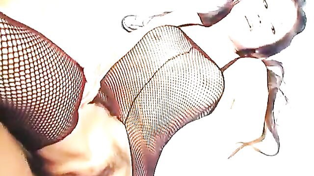 Asian teen in fishnet bodysuit exposing shaved pussy closeup