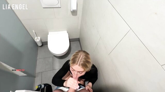 Lia Engel kneels sucking cock in public toilet bathroom