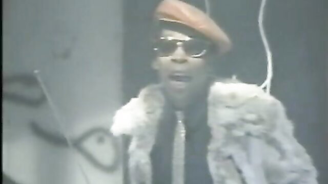 Retro 80s black man in fur coat, shades and hat in steamy VCA porn scene