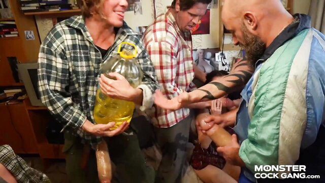 Monster Cock Gang men oiling huge dicks from yellow jug in amateur group