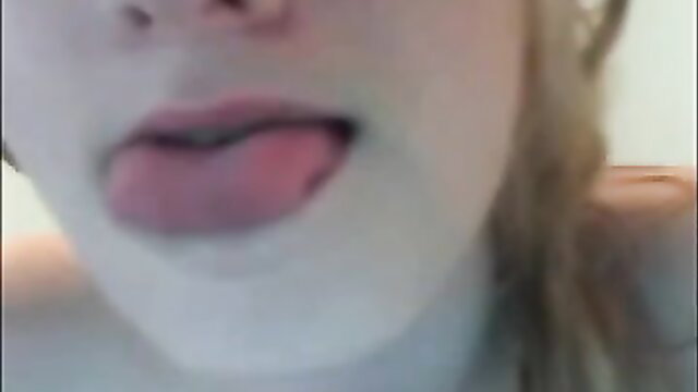Pale teen babe sticks out tongue, teases with open mouth closeup