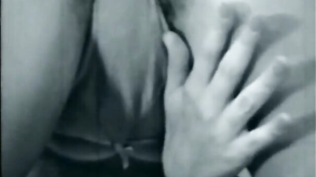 Vintage B&W closeup of woman's big natural tits squeezed by hands