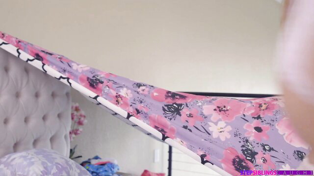 Moka Mora in pink floral sheet on bed, steamy lesbian tease