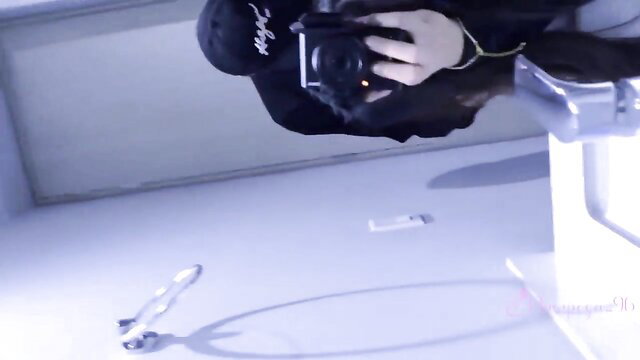 Rastico in black hoodie holds camera POV in bathroom after party