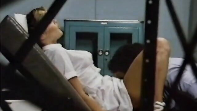 Retro nurse MILF in white dress spread on bed, sexy hospital tease