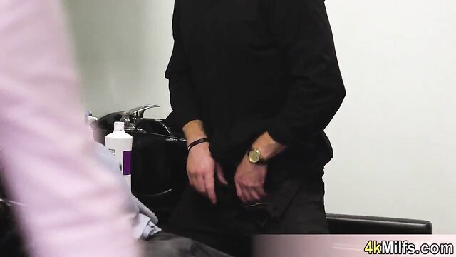 Bridgette B in salon with employee, hand near crotch