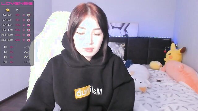 Asian babe Malisin in hoodie smiles cutely in solo toy play thumbnail