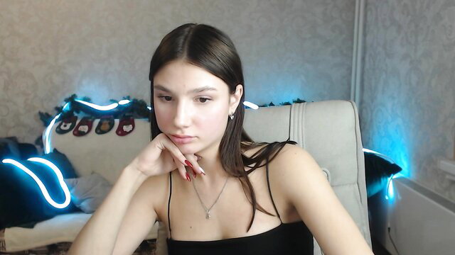 Lovelylavender Chaturbate camgirl in black tank top, thoughtful pose