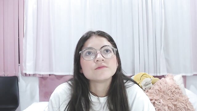 SweetMeegan webcam girl in glasses smiling on bed