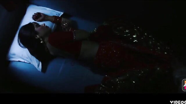 Indian bride in red saree sleeping on bed, erotic honeymoon tease