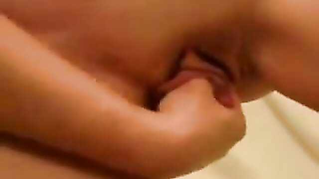 Mature woman with sexy long labia, hand spreading wet pussy closeup