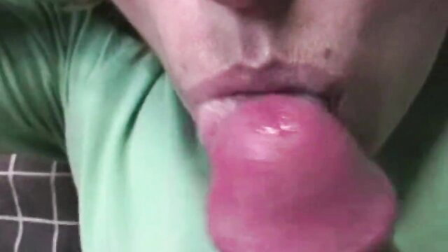 Closeup of woman sticking out wet pink tongue, ready to swallow cum