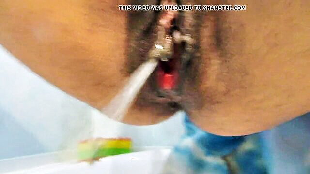 Closeup of pierced pussy getting powerful piss stream post-sex