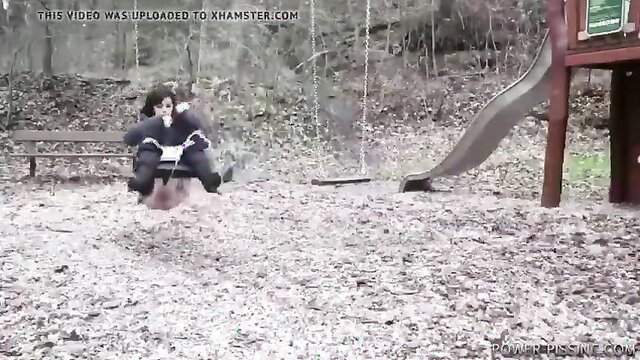 Two women on swing in park, one pissing outdoors amateur style