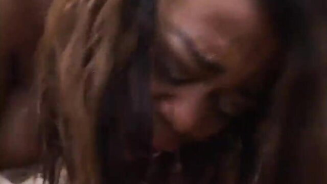 Closeup of black woman's ecstatic face with dreads in interracial creampie