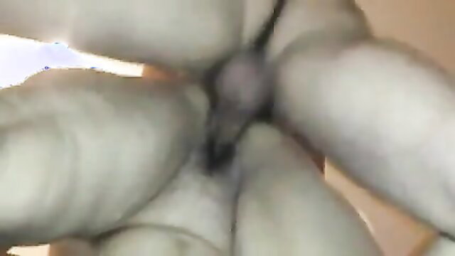 Mature closeup of pale pussy lips spread with dark dildo insertion