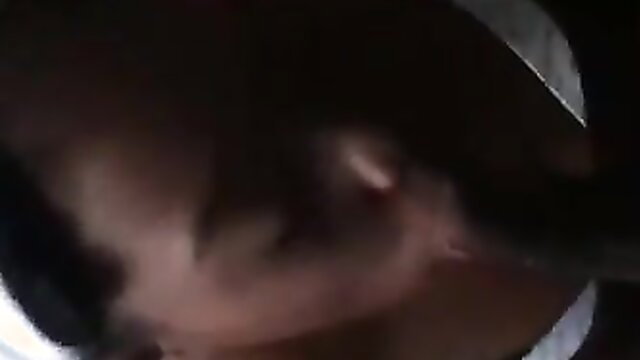 Blurry closeup of mature woman's face and neck in dim light