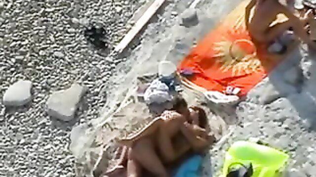 Spy cam of two couples fucking doggy style on sunny beach