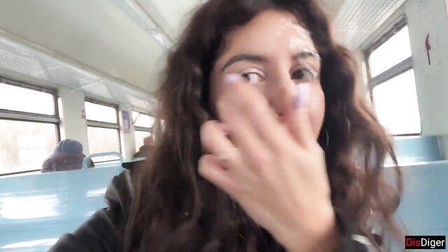 Katty West with cum on face, hand over mouth on train public oral