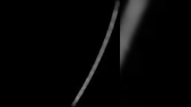 Intense latex metal bondage with woman restrained in dark fetish scene