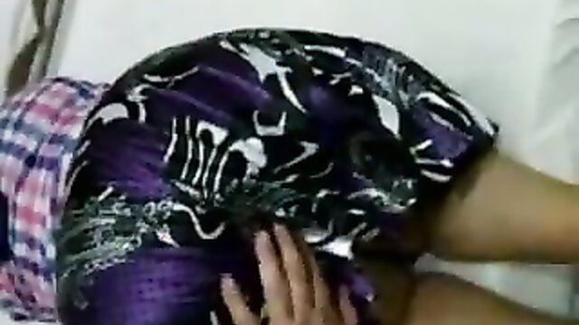 Amateur Turkish woman in purple skirt bent over, grabbing ass on bed